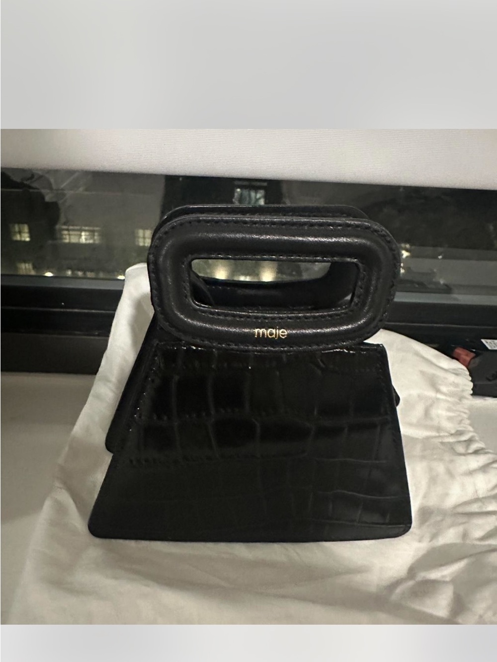 Maje Black Croc-Embossed Mini Top-Handle Bag also comes with a long strap